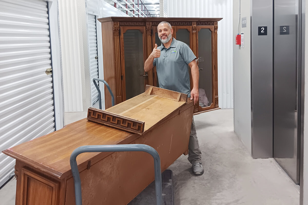 Jose Showing thumbs up while removing the Big wooden Cupboard