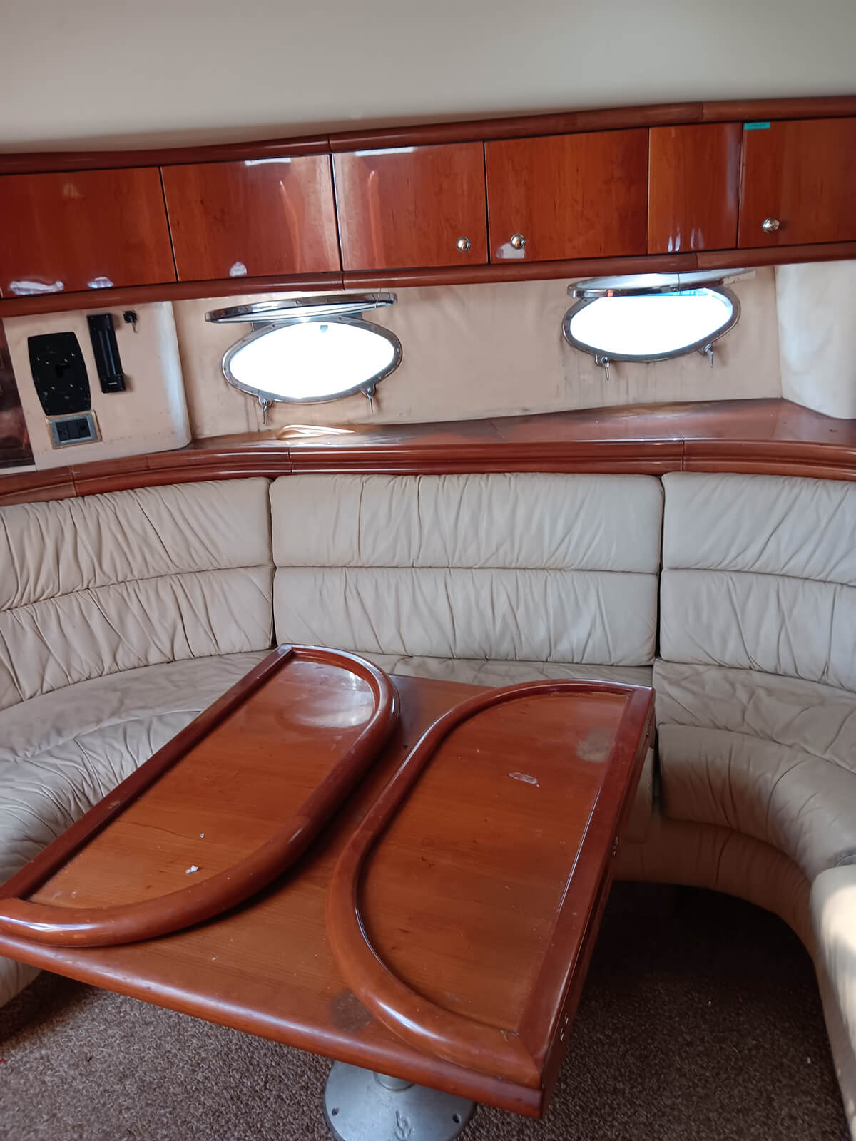 the inside of a boat with a couch and table