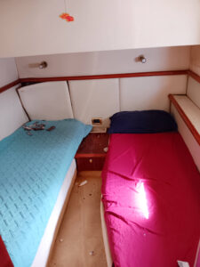the inside of a small boat with two beds