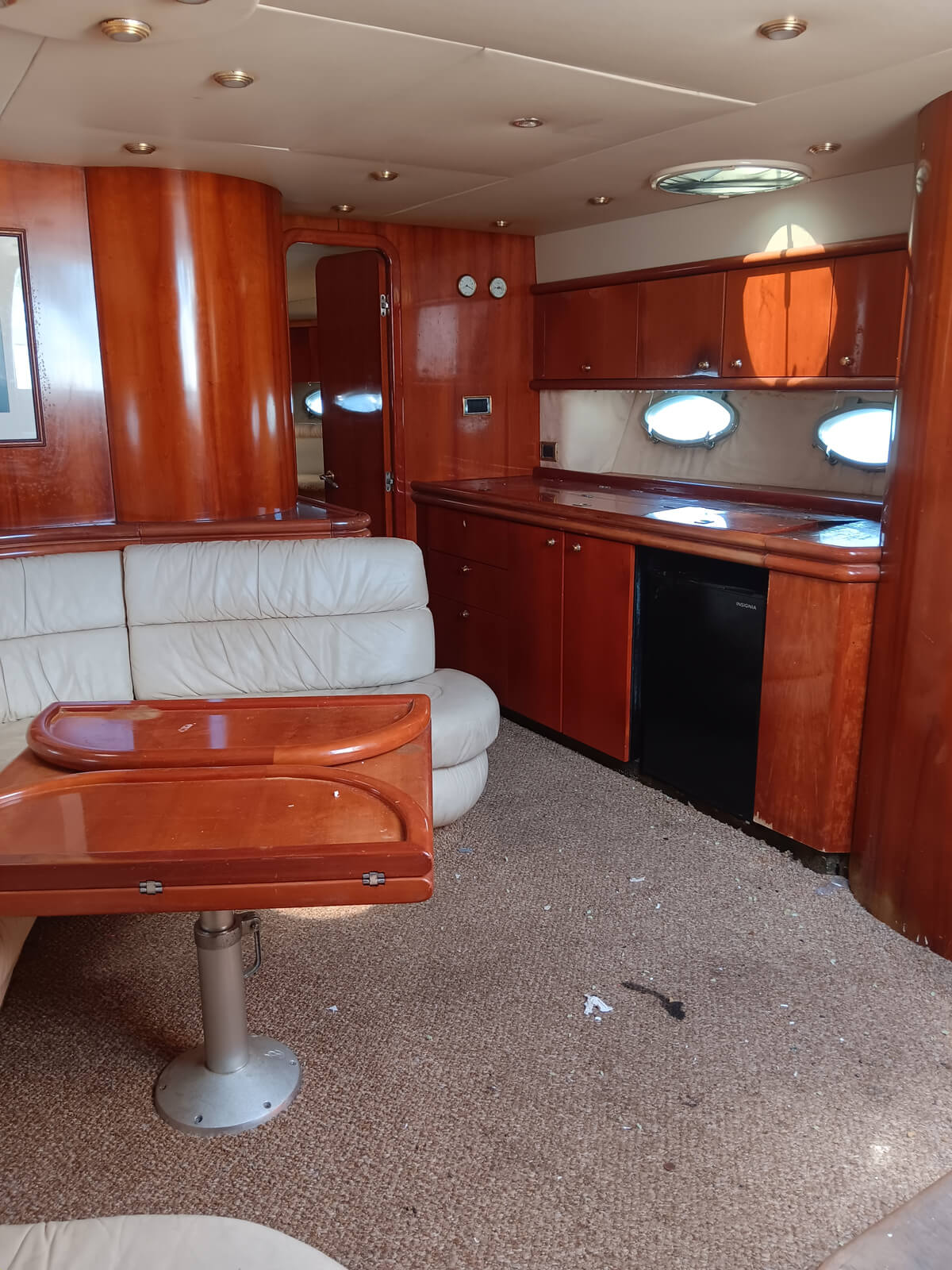 the inside of a boat with leather couches and a table