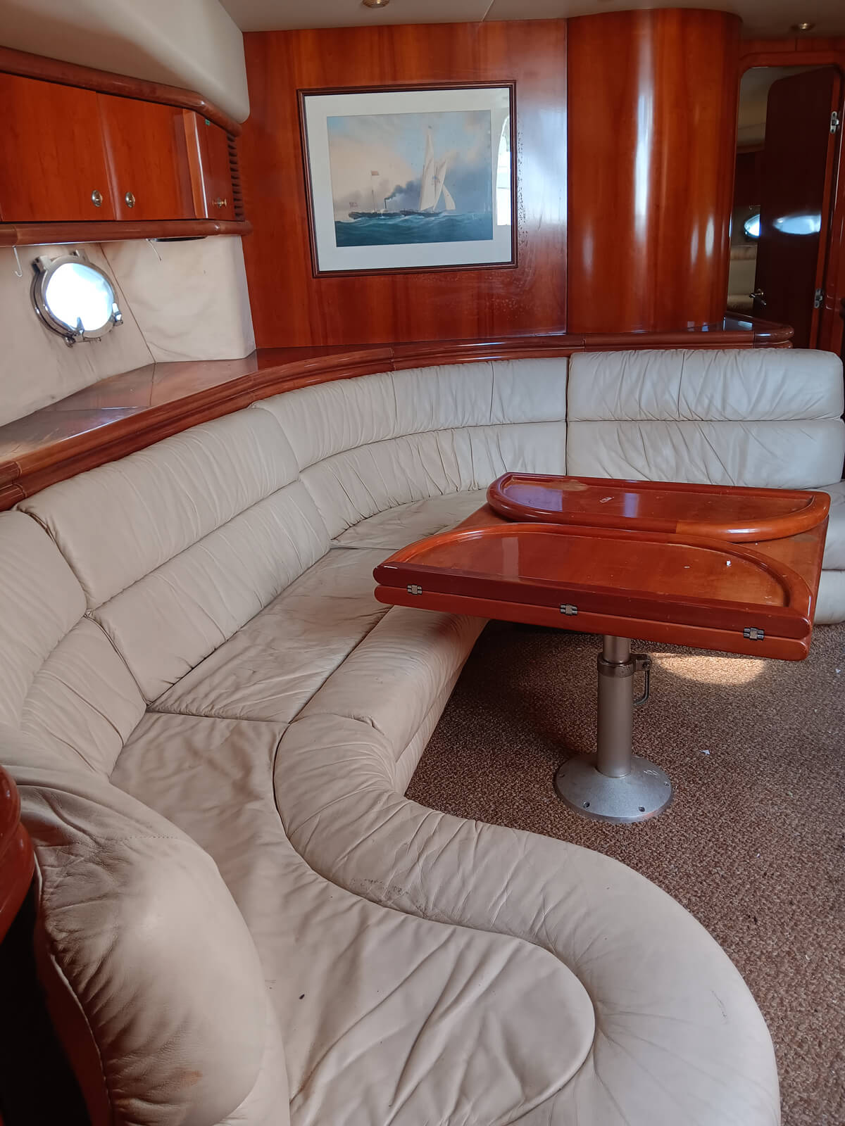 the inside of a boat with leather couches and a table