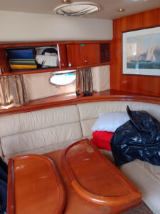 the inside of a boat with a couch and table