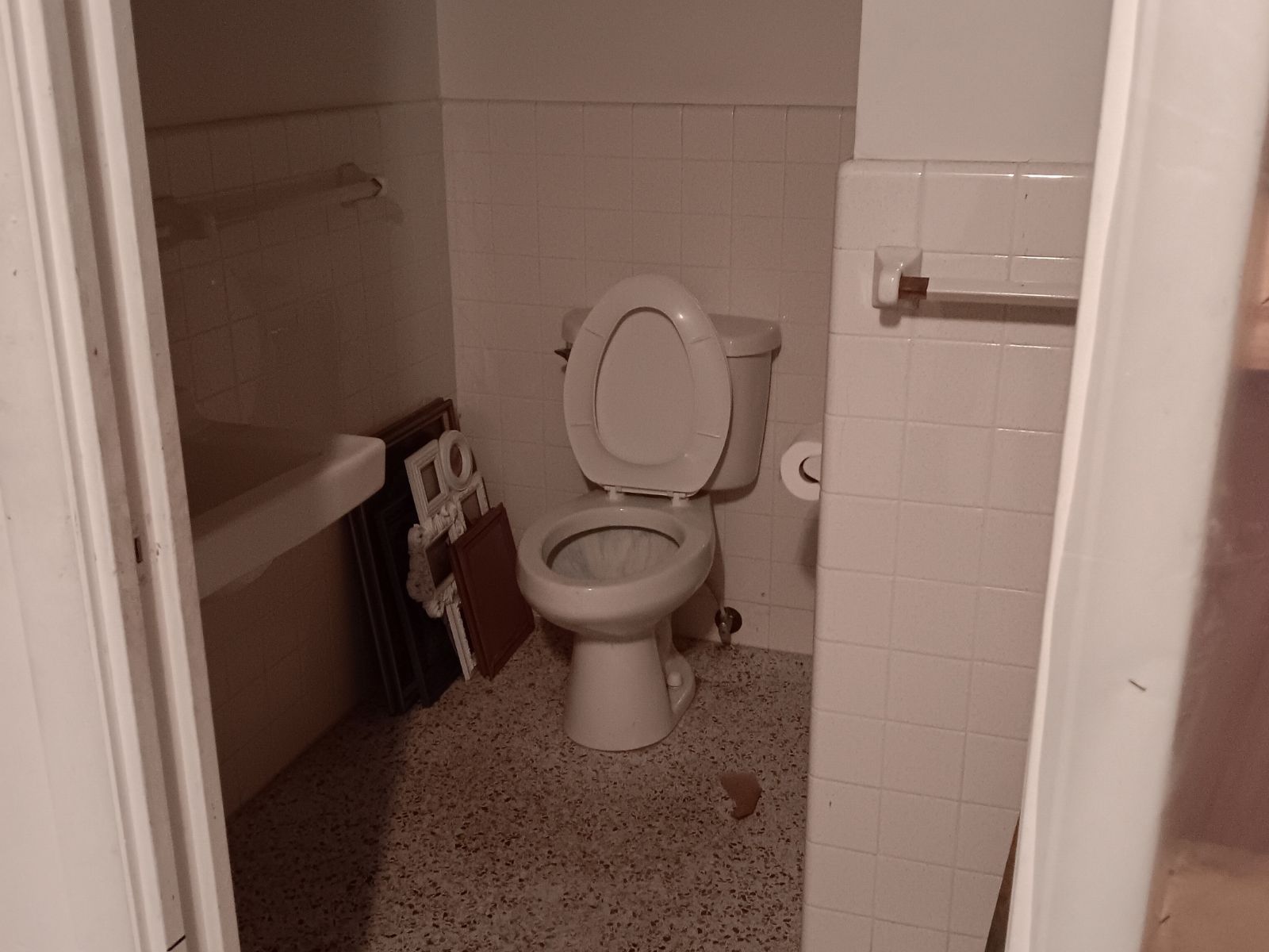 Bathroom with toilet and frames awaiting fixture removal