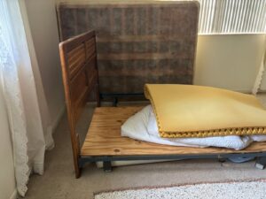 Wooden bedframe and mattress prepared for removal