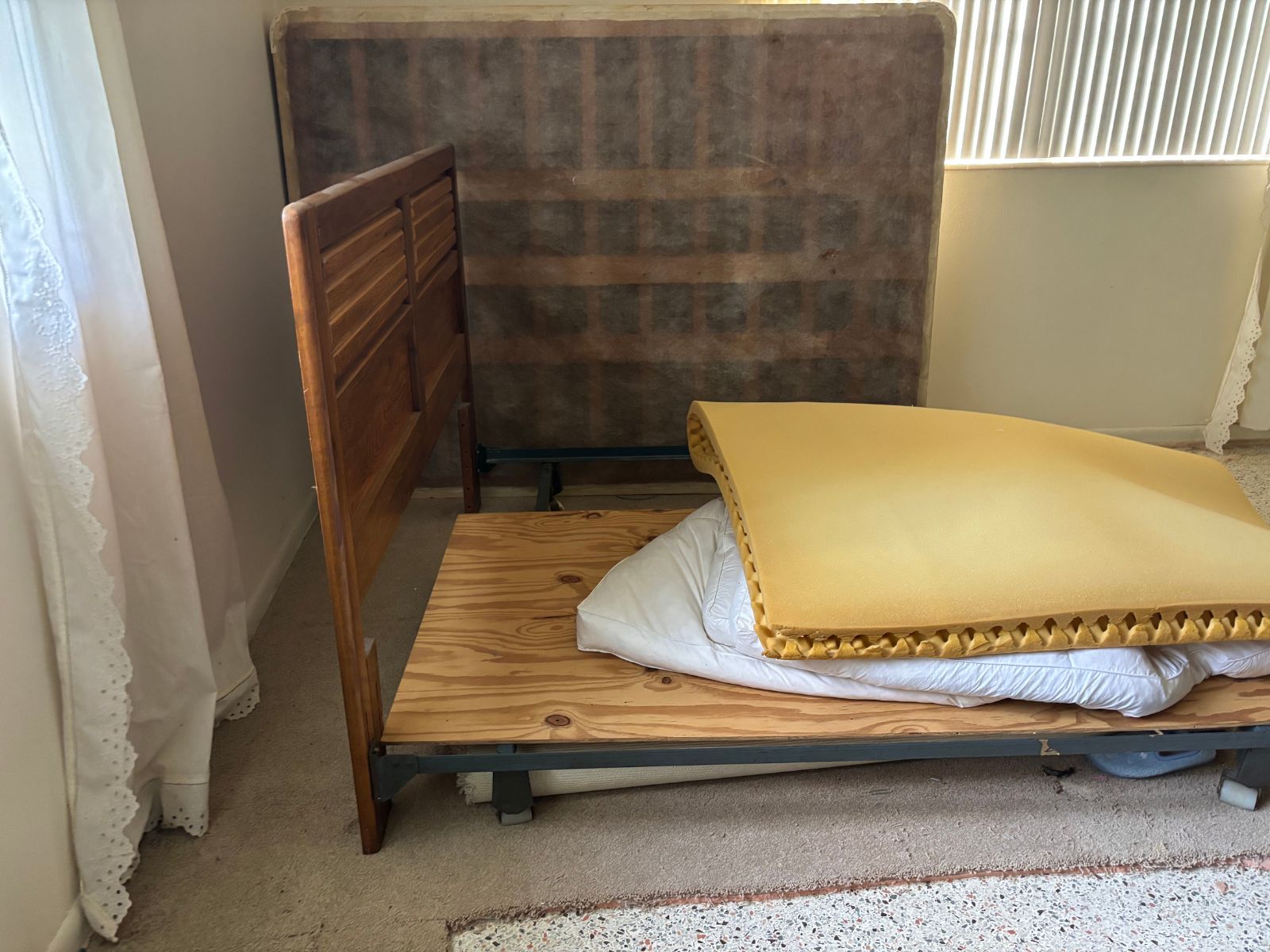 Wooden bedframe and mattress prepared for removal