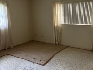 Bedroom with carpet removed during Brandon house cleanout