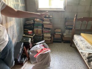 Stacks of books and clutter ready for Brandon house cleanout