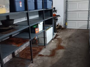 Garage with metal shelving and bins ready for junk removal