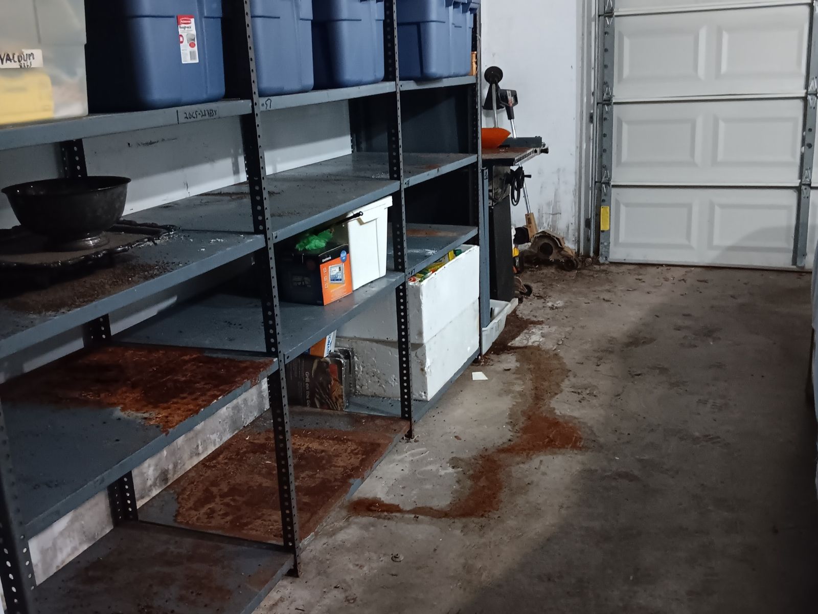 Garage with metal shelving and bins ready for junk removal