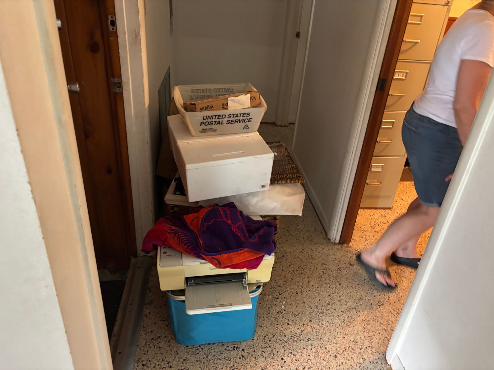 Hallway cluttered with boxes and items for junk hauling