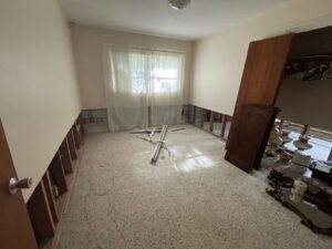 Bedroom in Brandon home with debris on floor awaiting junk removal
