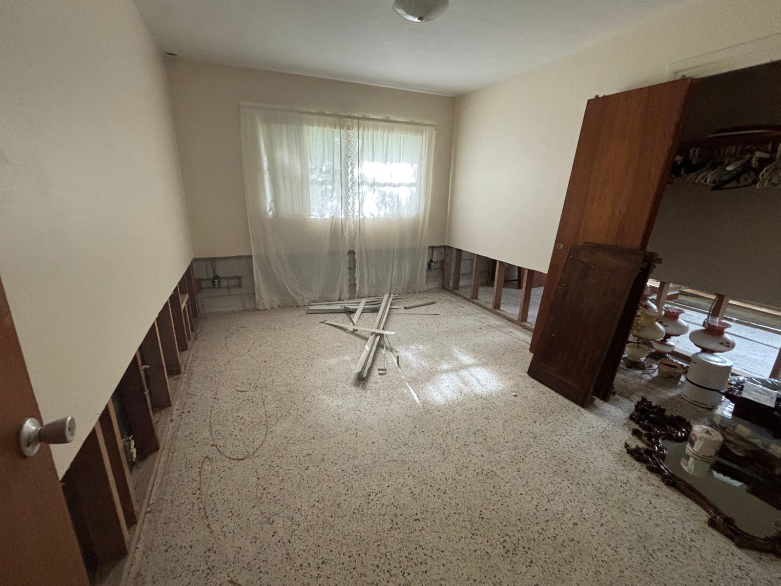Bedroom in Brandon home with debris on floor awaiting junk removal