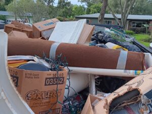 Large pile of junk curbside ready for Brandon junk hauling
