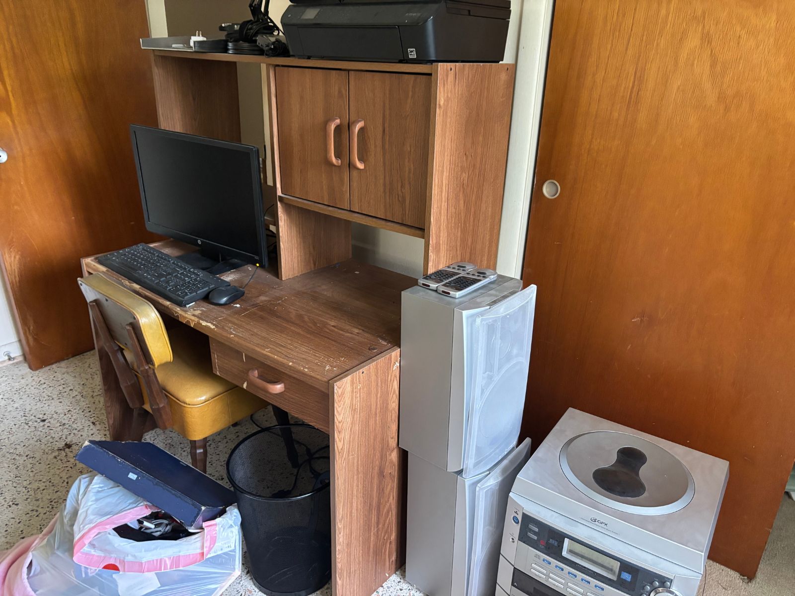 Old desk, chair, and electronics ready for office junk removal